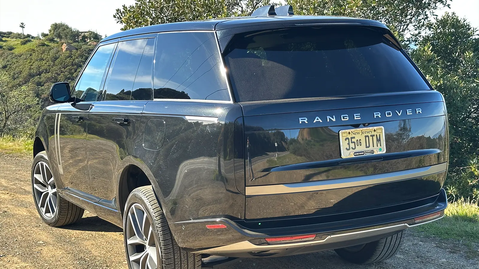 A black 2025 Land Rover Range Rover SE PHEV Review three quarter rear view