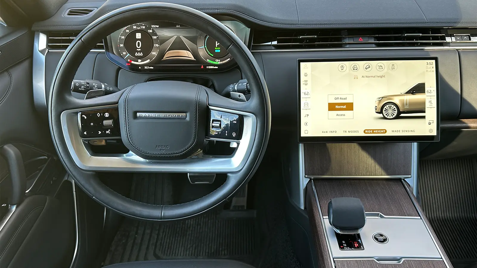 A black 2025 Land Rover Range Rover SE PHEV Review interior driver front view