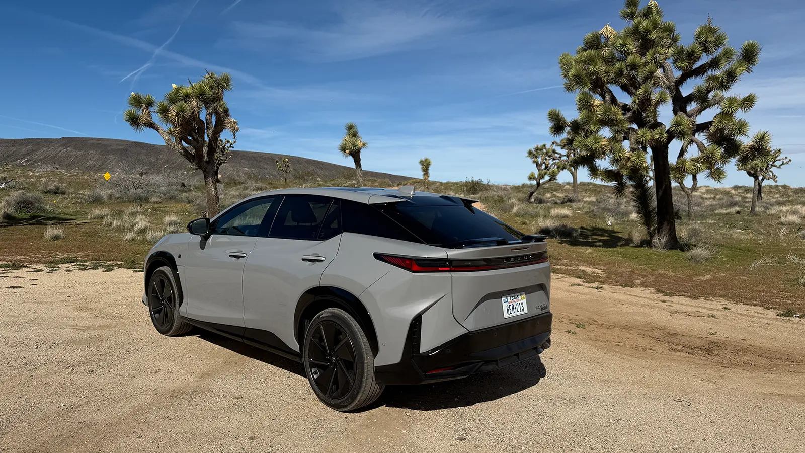 A gray 2026 Lexus RZ550e F Sport Review rear three quarter view