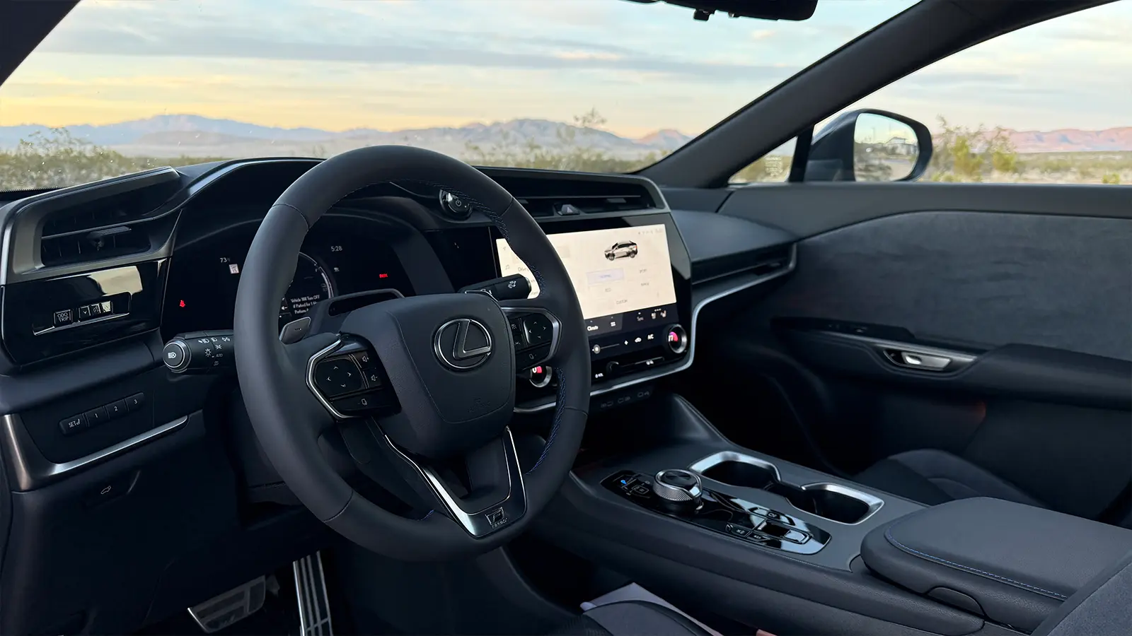 A gray 2026 Lexus RZ550e F Sport Review interior front view drivers side