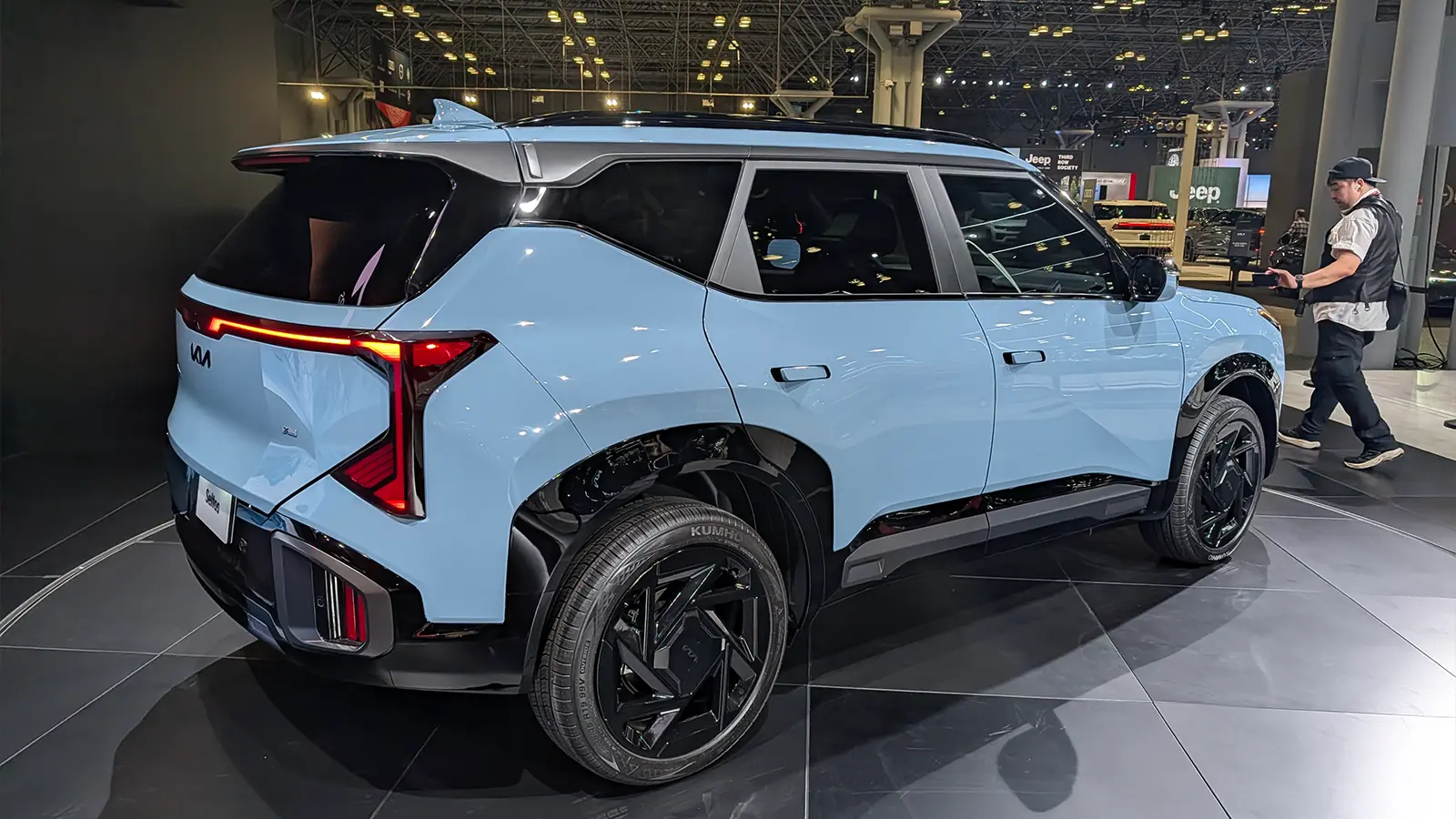 A light blue Kia Seltos three quarter rear view