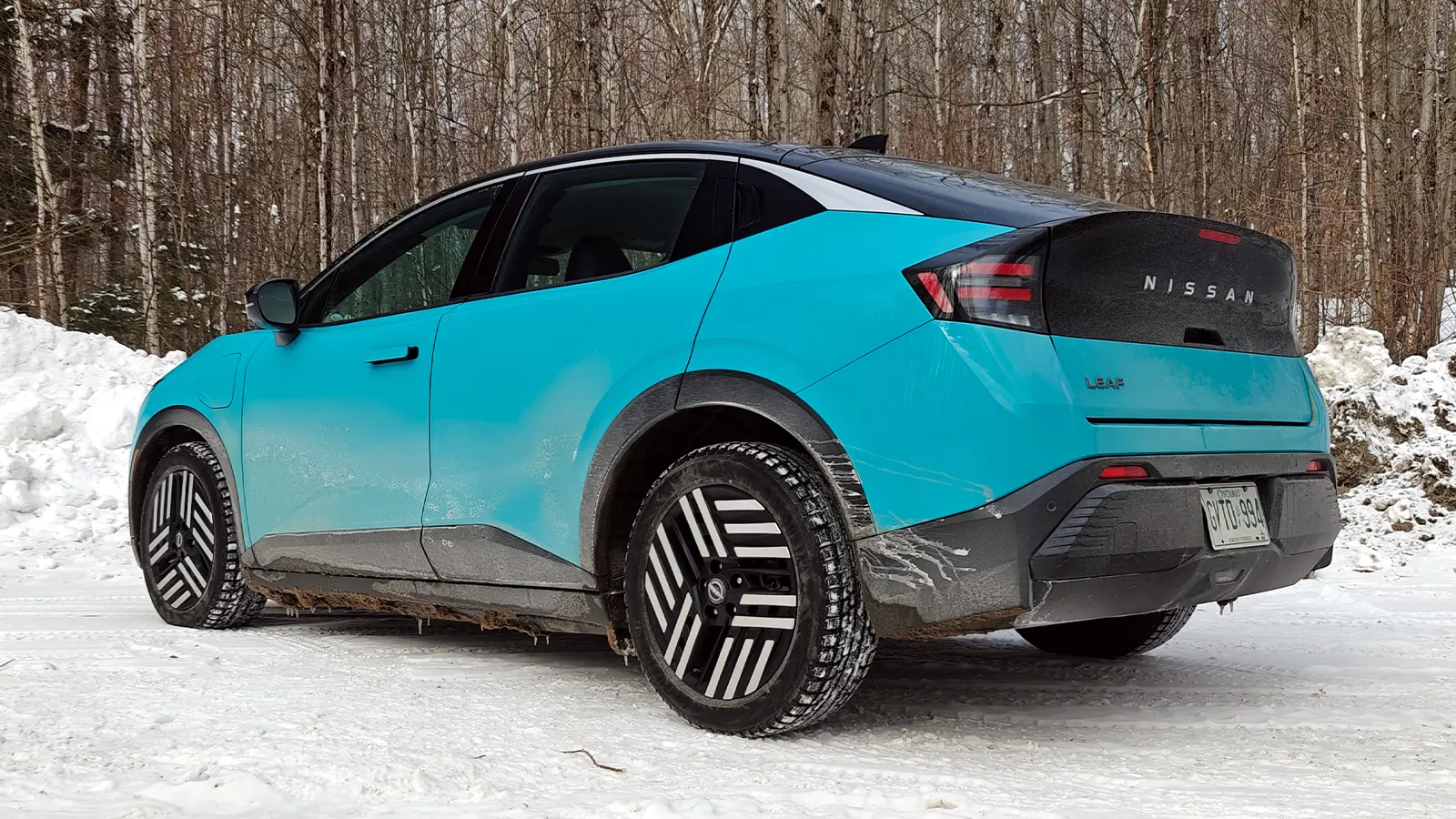 A teal 2026 Nissan Leaf three quarter rear view