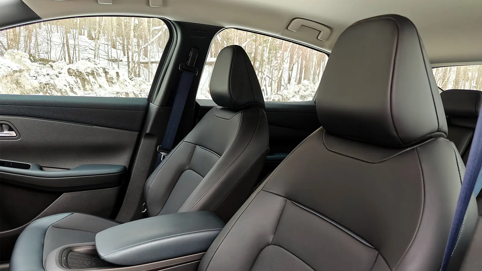 A teal 2026 Nissan Leaf interior driver side view