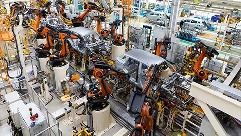 An EV assembly line factory putting together EV's