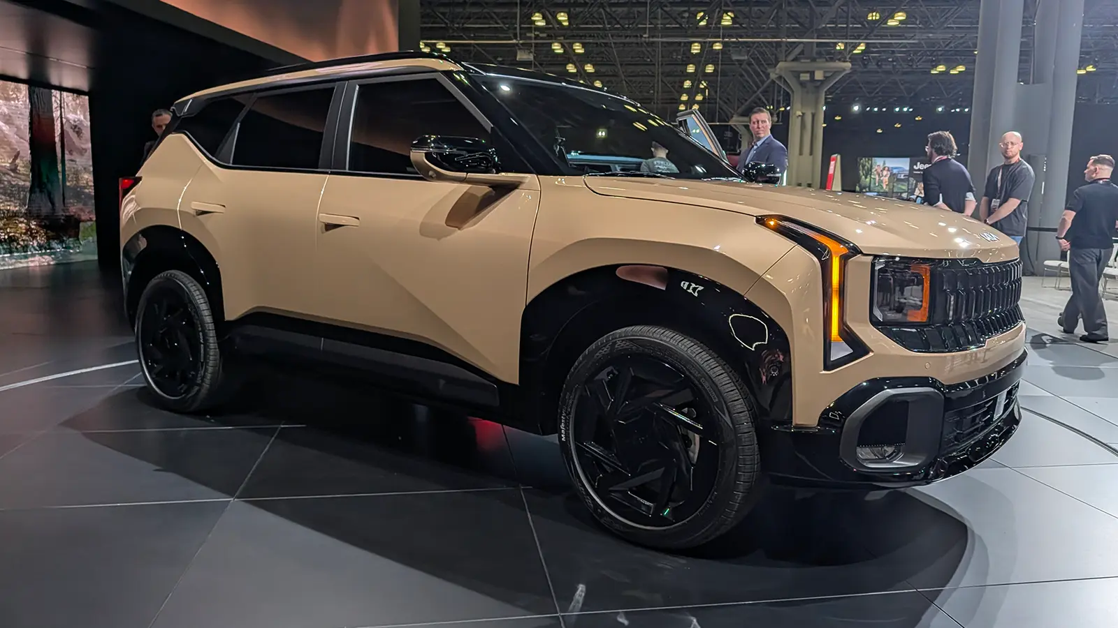 A light gold 2027 Kia Seltos three quarter front view at the 2026 NY Auto Show