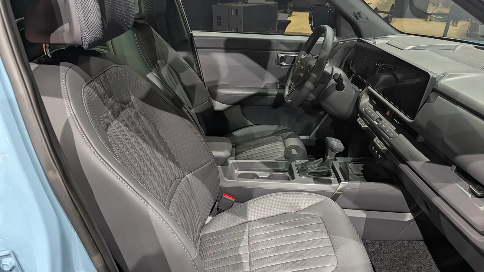 A light gold 2027 Kia Seltos interior driver front side view at the 2026 NY Auto Show