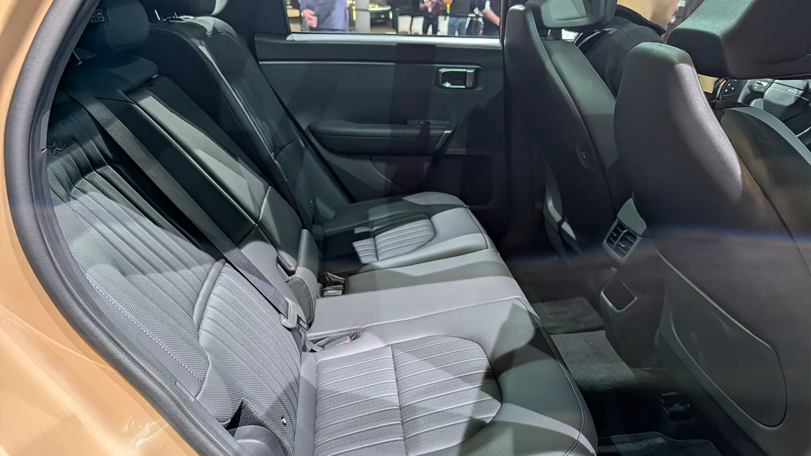 A light gold 2027 Kia Seltos interior rear seat side view at the 2026 NY Auto Show