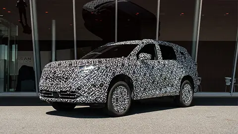 A 2027 Rogue e Power prototype first drive three quarter front view 