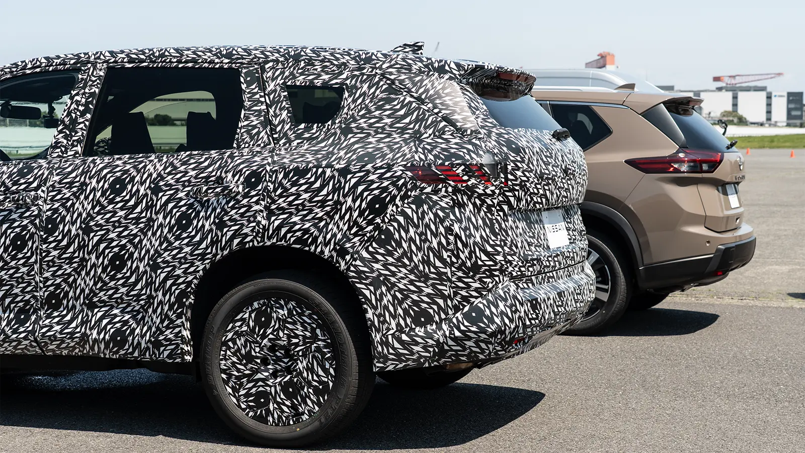 A 2027 Rogue e Power Prototype First Drive actual three quarter rear view both side by side