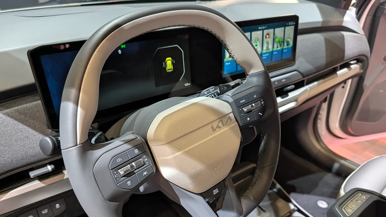 A white 2027 Kia EV3 interior driver front dashboard view