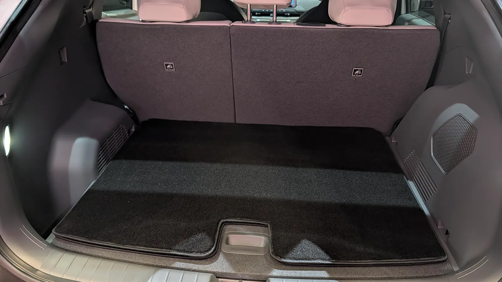 A white 2027 Kia EV3 rear trunk open view