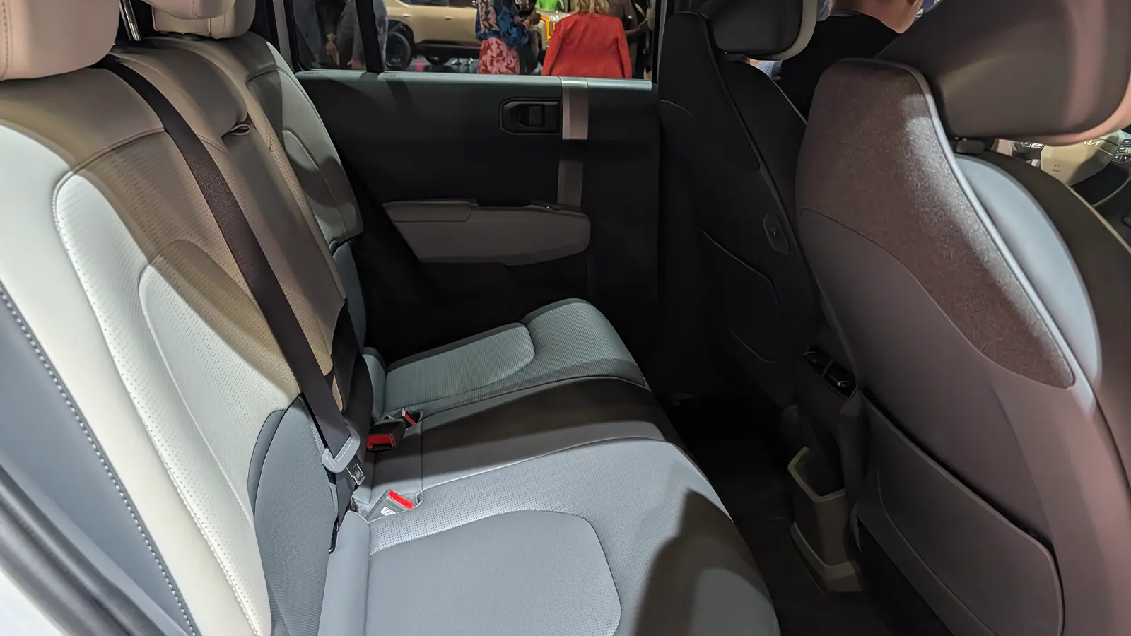 A white 2027 Kia EV3 interior rear second row seats side view