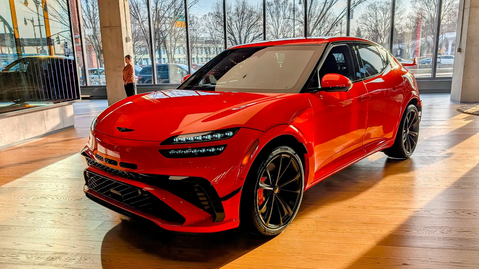 A 2027 Orange Genesis GV60 Magma three quarter front view