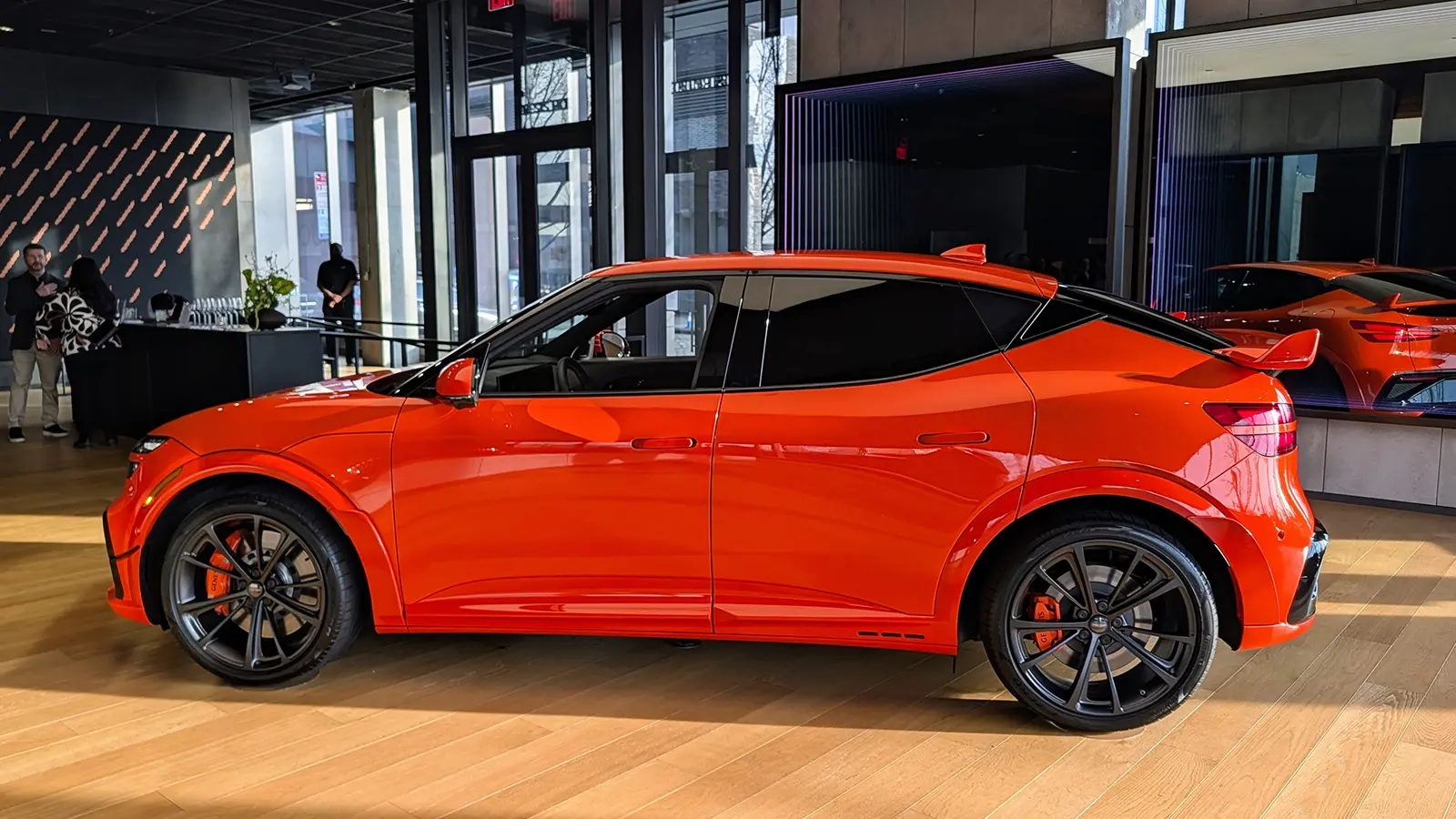 A 2027 Orange Genesis GV60 Magma side view