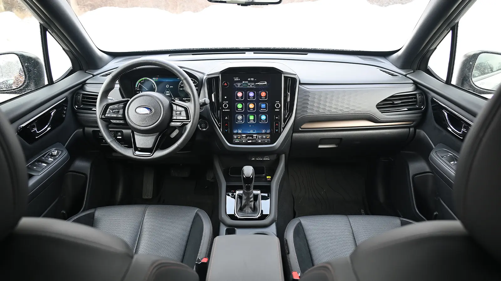 A dark gray 2025 Subaru Forester Touring hybrid interior front HUD view