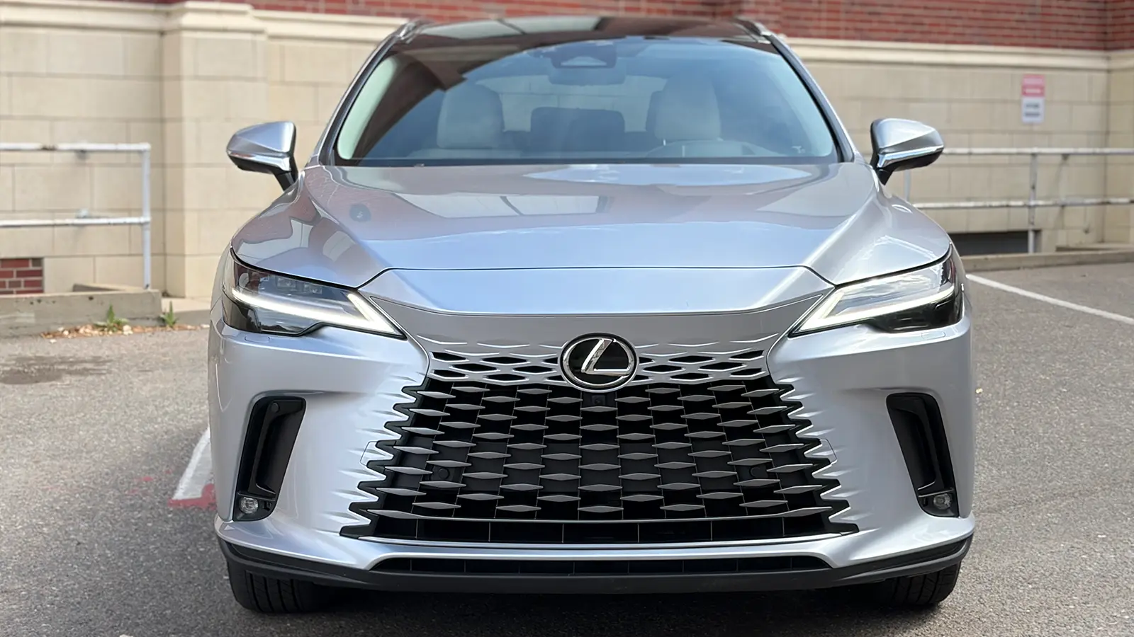 A silver Lexus RX 450h+ front nose view