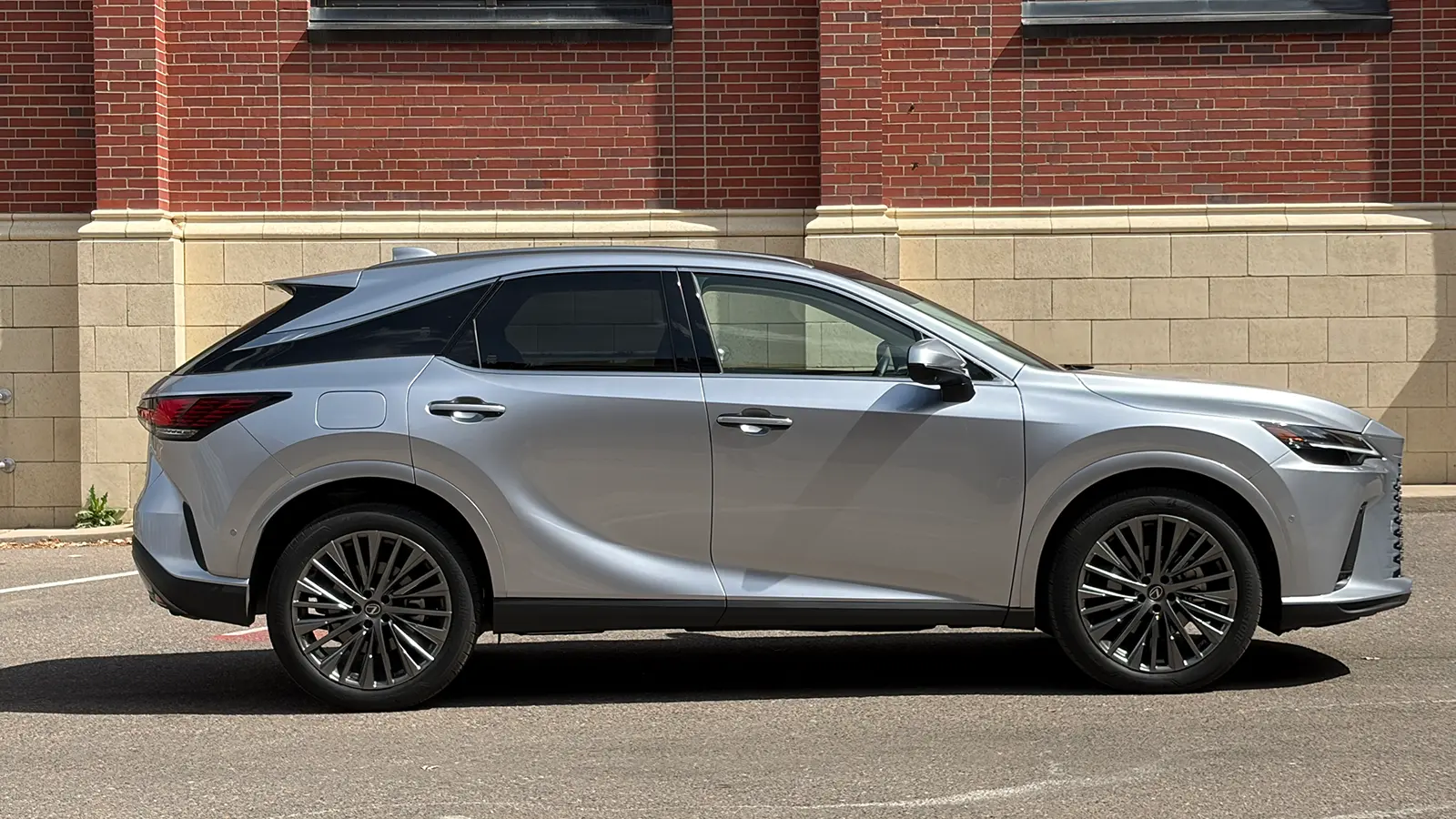 A silver Lexus RX 450h+ side view