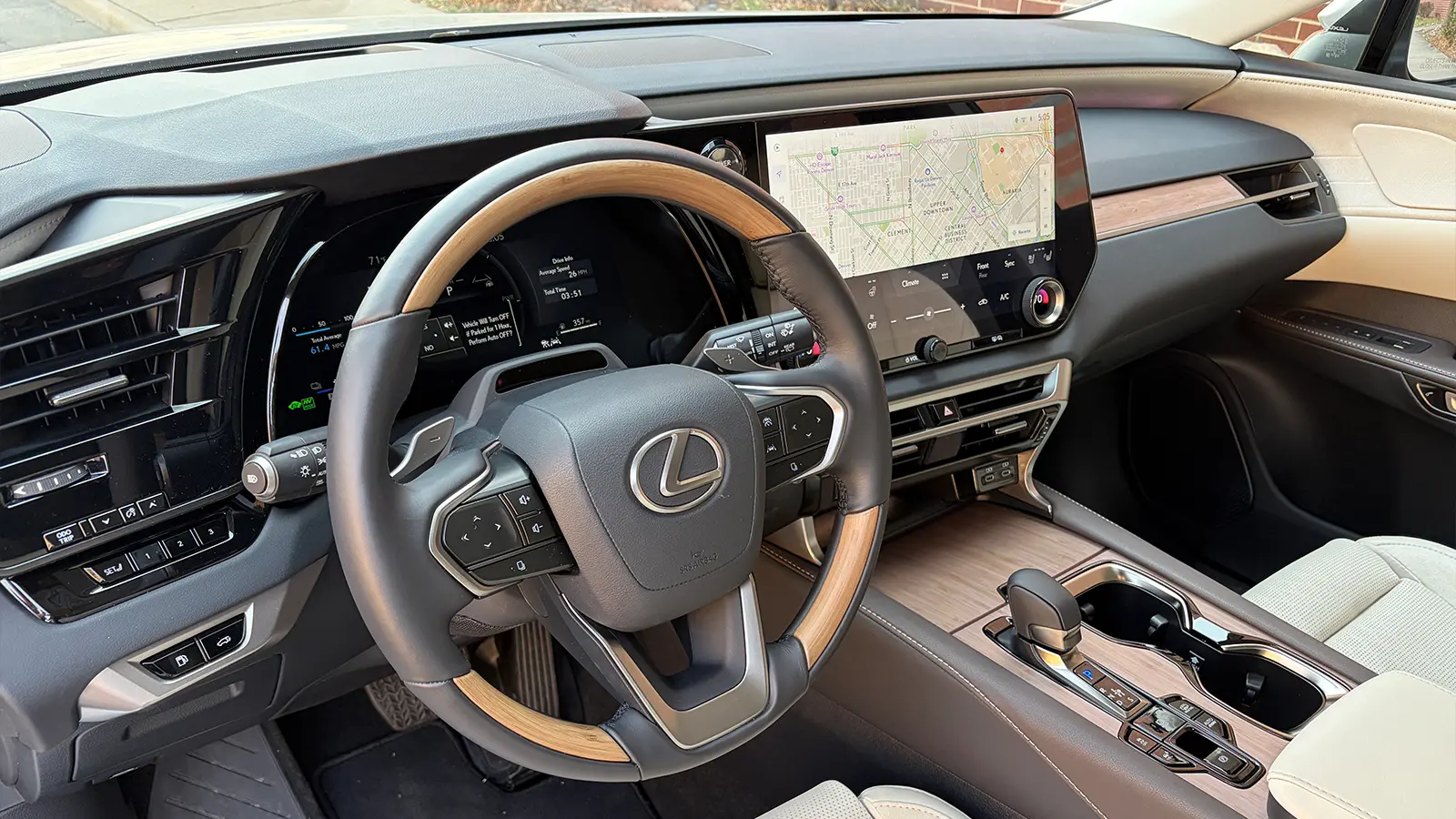 A silver Lexus RX 450h+ interior driver front HUD dashboard view
