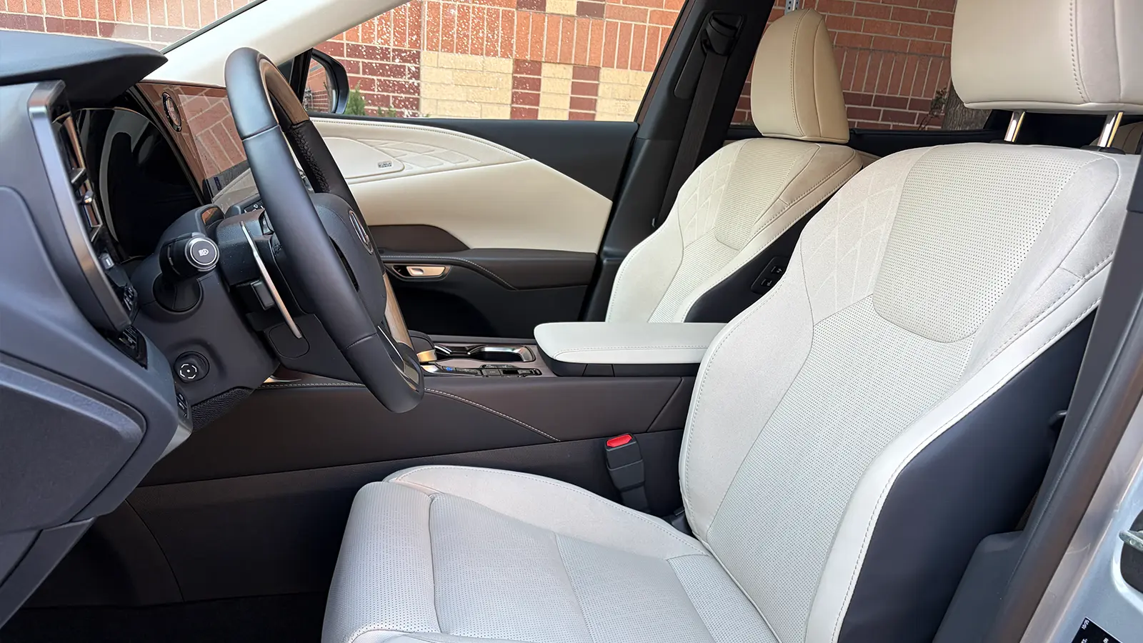 A silver Lexus RX 450h+ interior driver side view