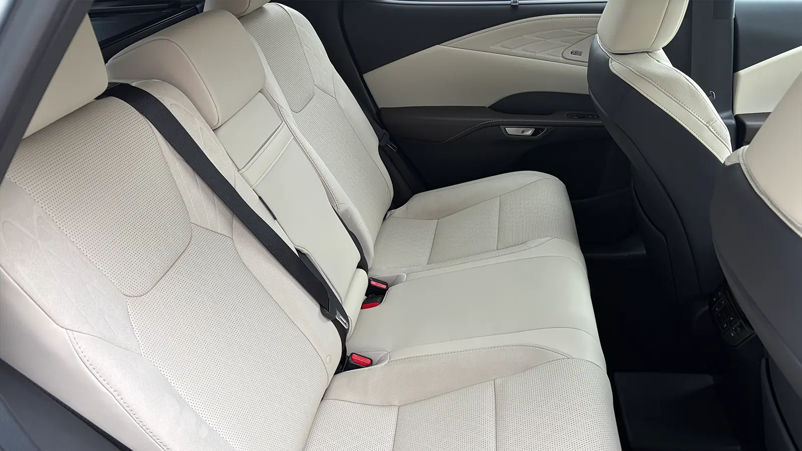 A silver Lexus RX 450h+ interior second row side view