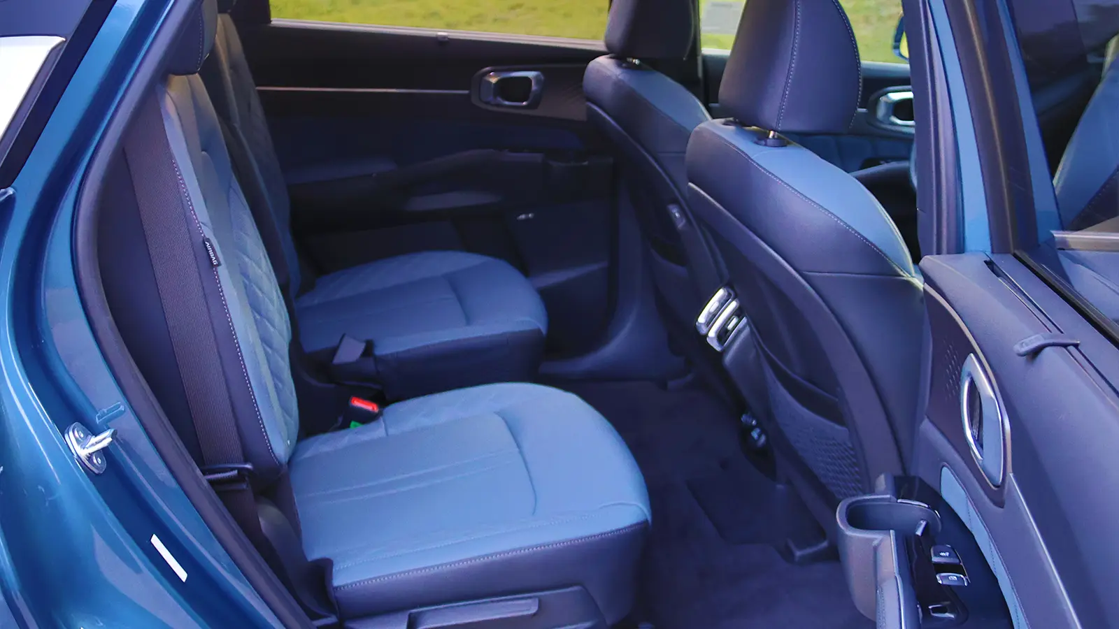A blue 2026 Kia Sorrento hybrid second row side view
