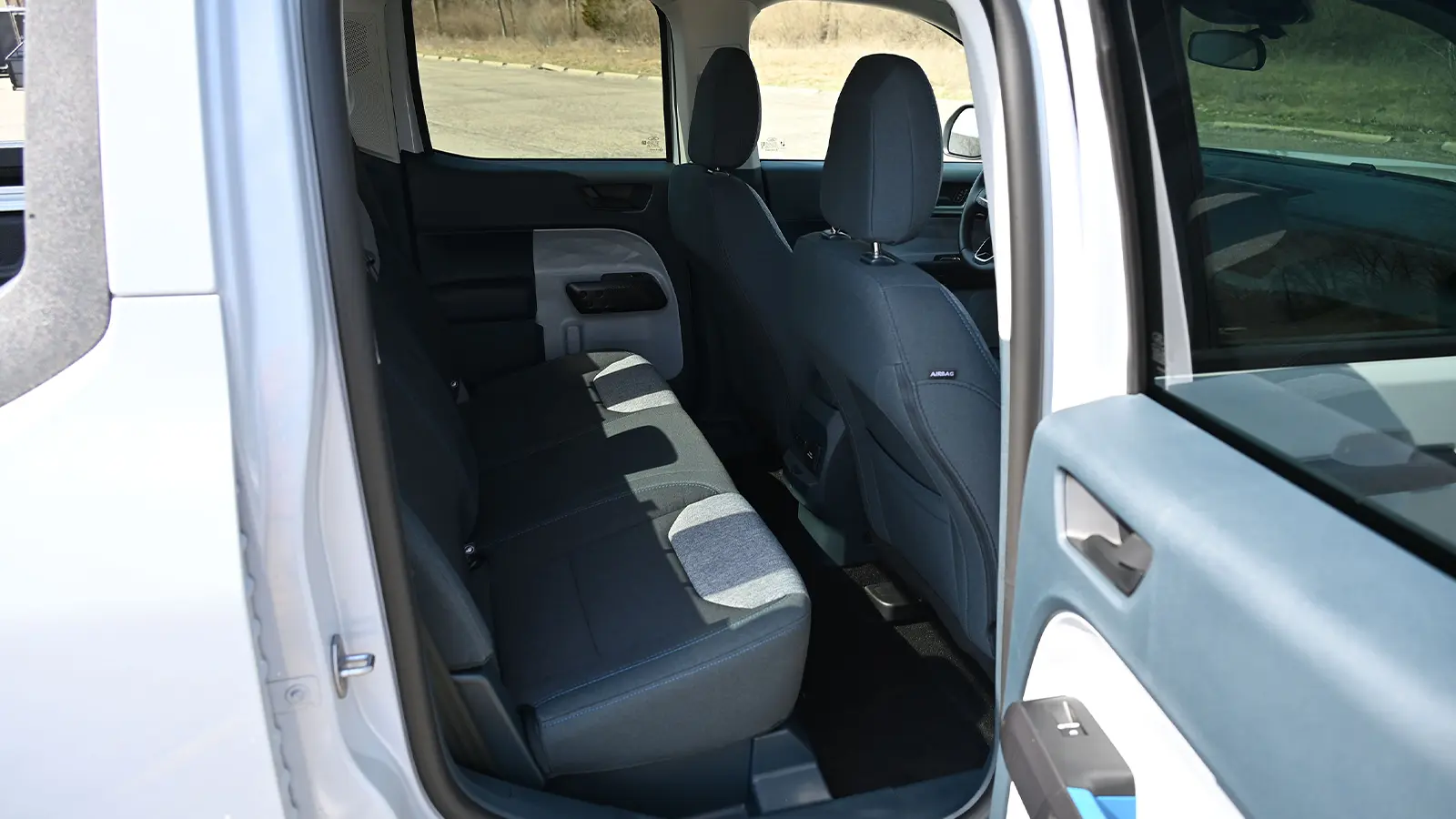 A white 2025 Ford Maverick AWD Hybrid rear seat side view
