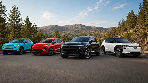 A line up of the Chevrolet Equinox EV, Chevrolet Bolt, Nissan Leaf and a hyundia Ioniq 5