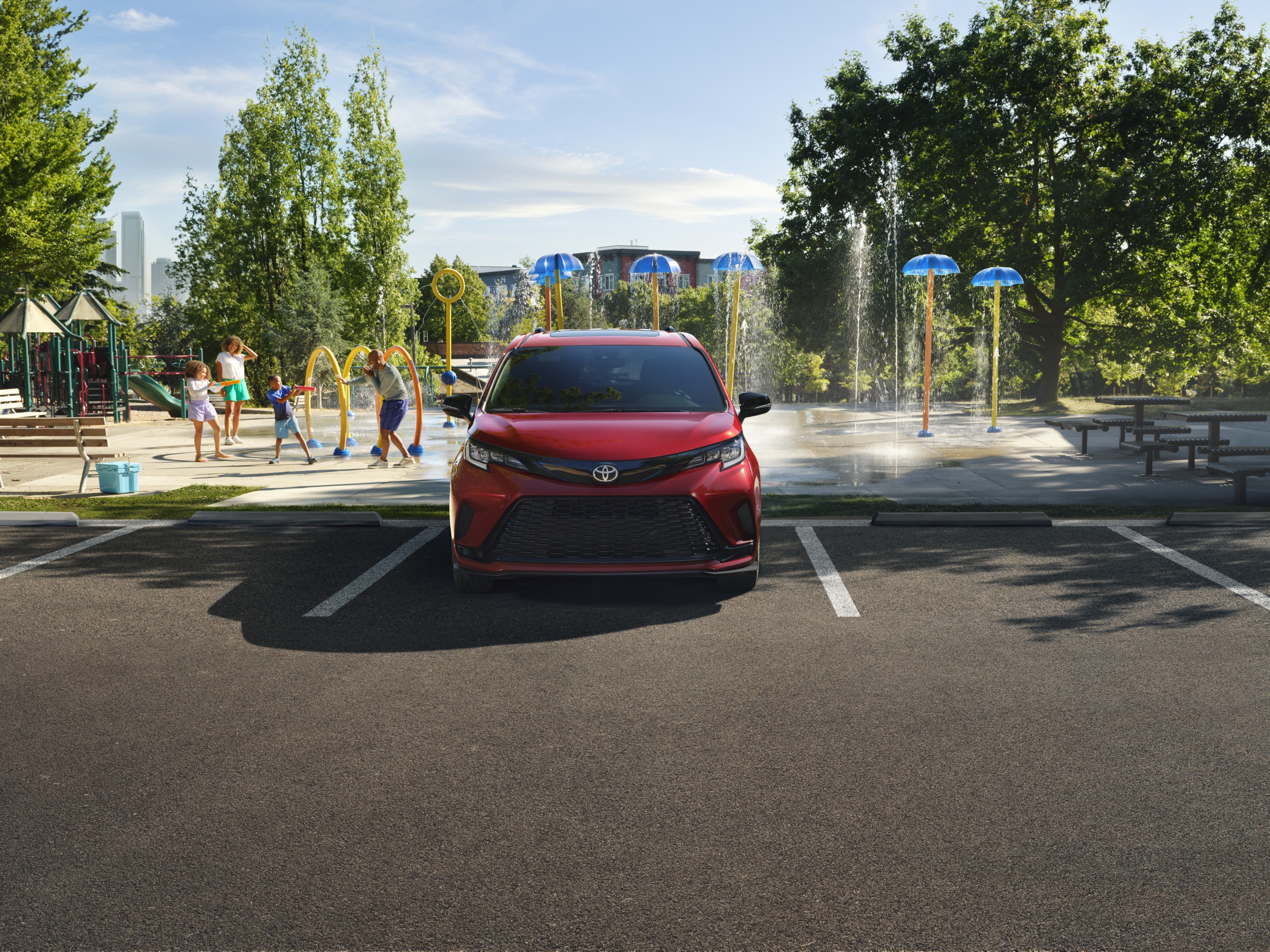 A red 2026 Toyota Sienna Hybrid parked at a waterpark