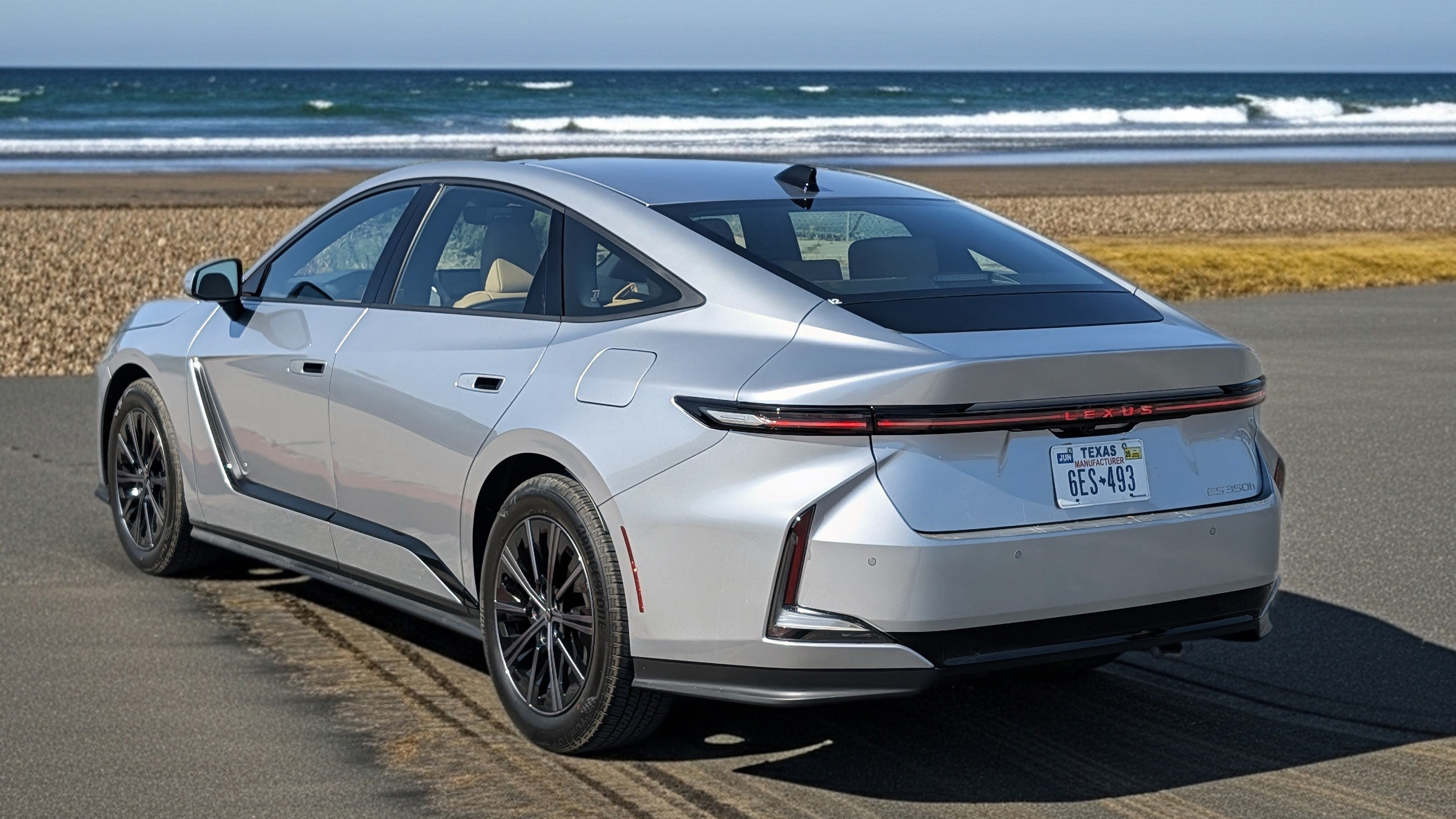 2026 Iridium Lexus ES350h rear exterior view parked at a beach