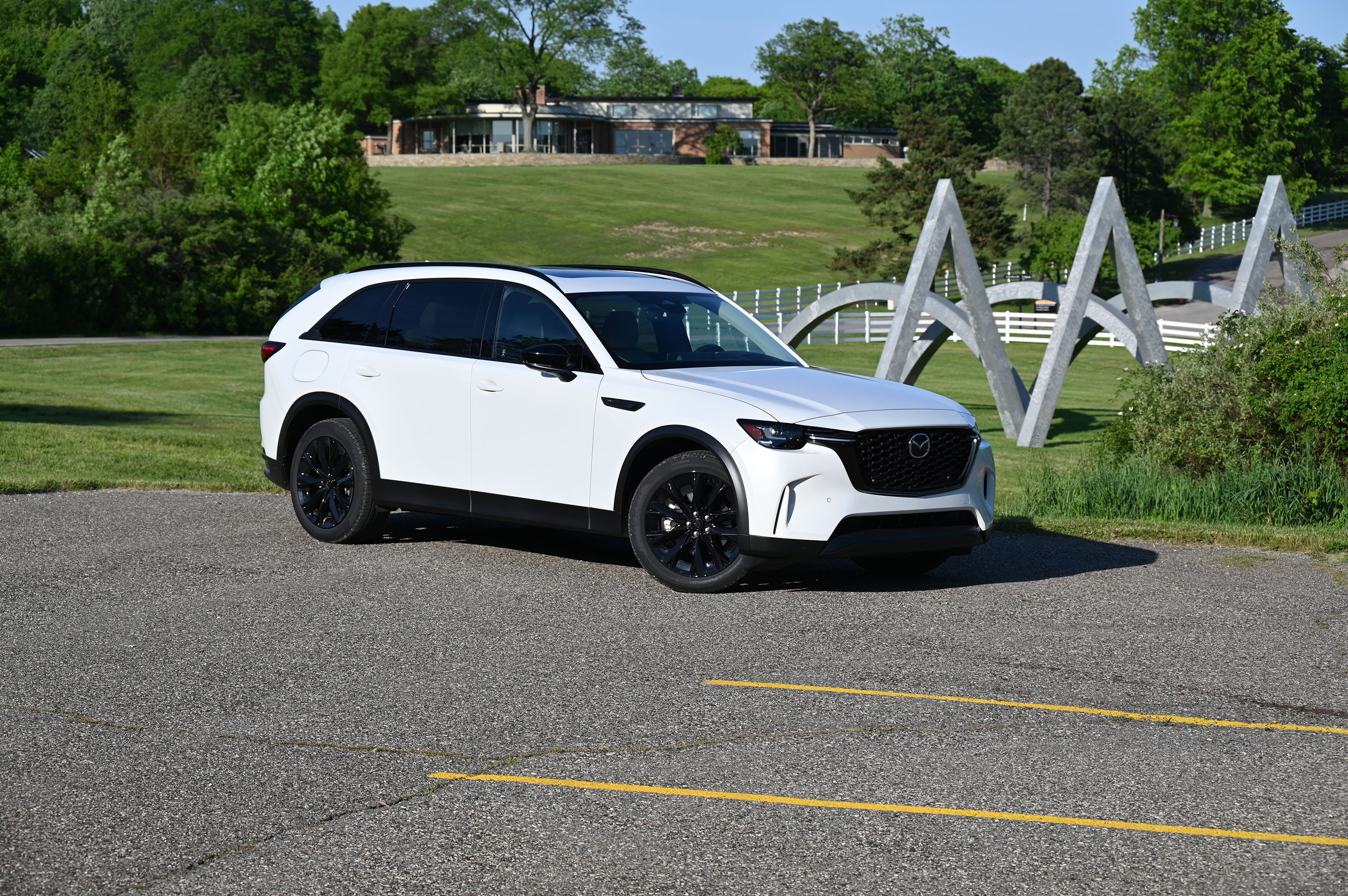 White 2026 Mazda CX-90 standing next to a park
