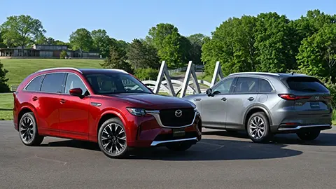 Red and White Mazda-CX-90 2026 standing next to each other at a parking lot next to a park