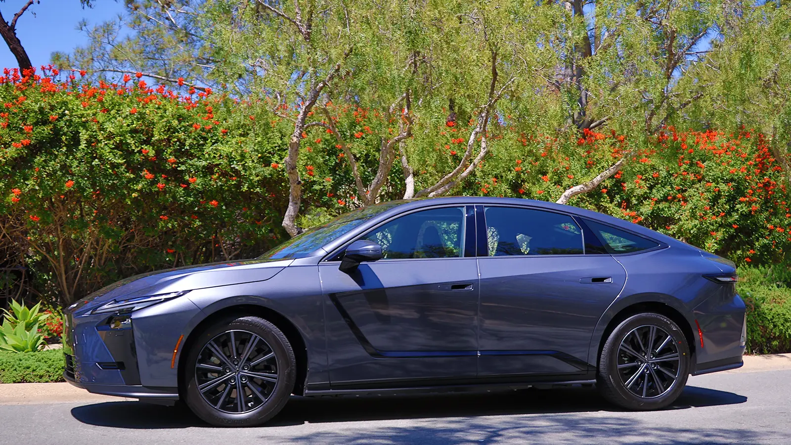 2026 Lexus ES350e ES500e Wavelength parked next to a bush with red flowers
