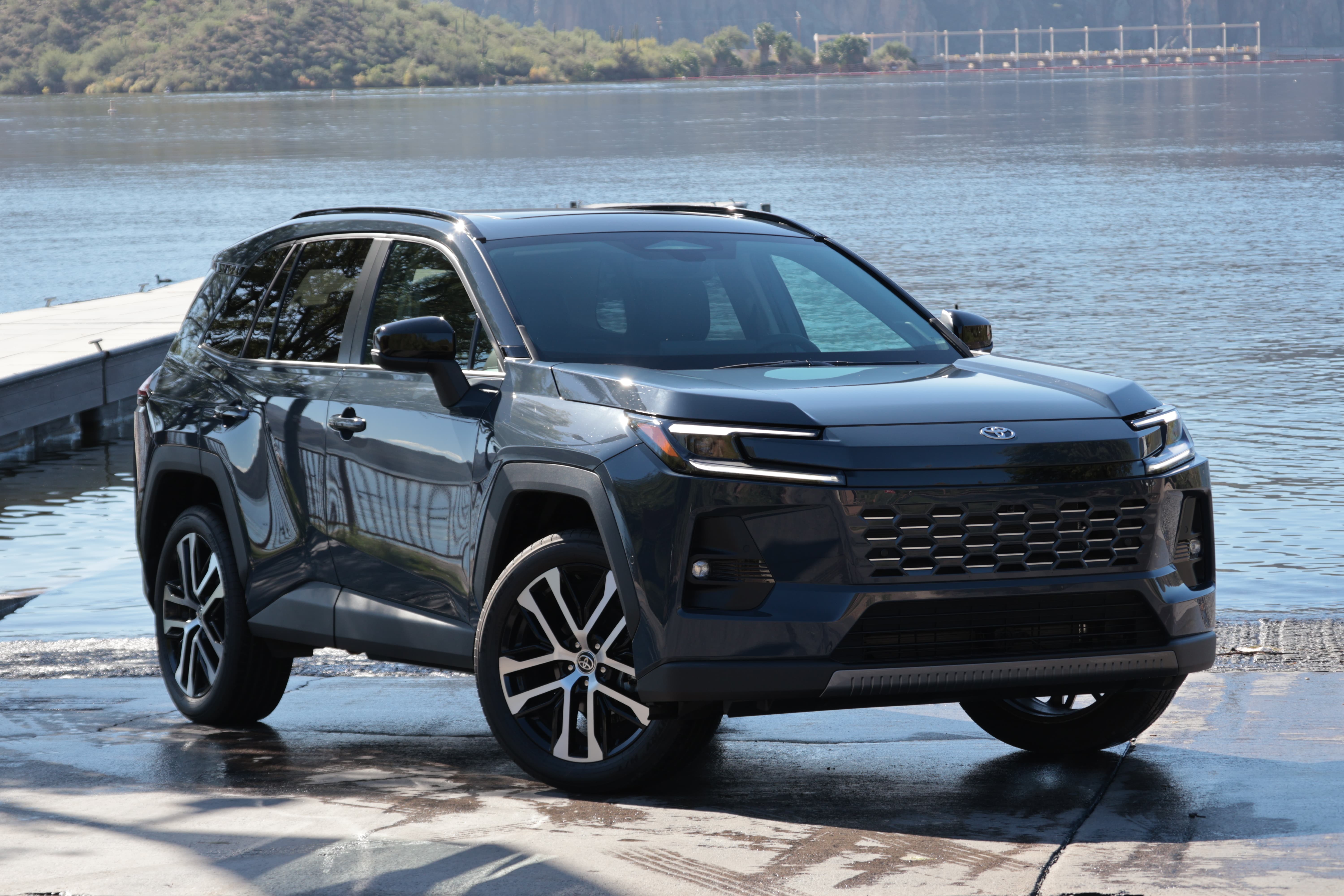 2026 Black Toyota RAV4 parked next to a lake pier