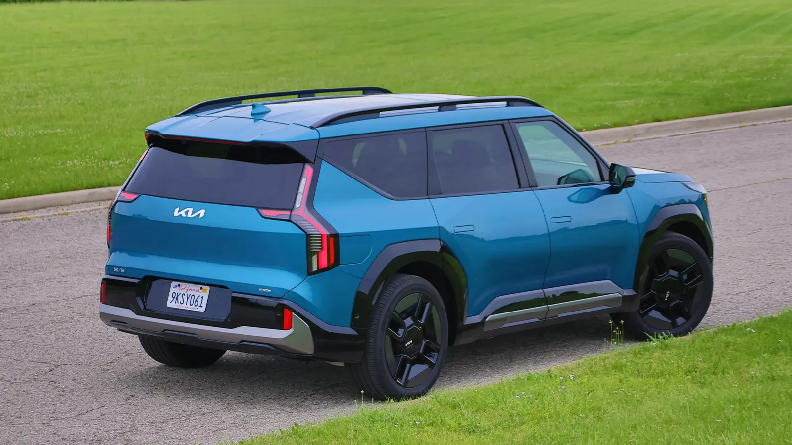 A blue 2026 Kia EV9 GT Line three quarter rear view