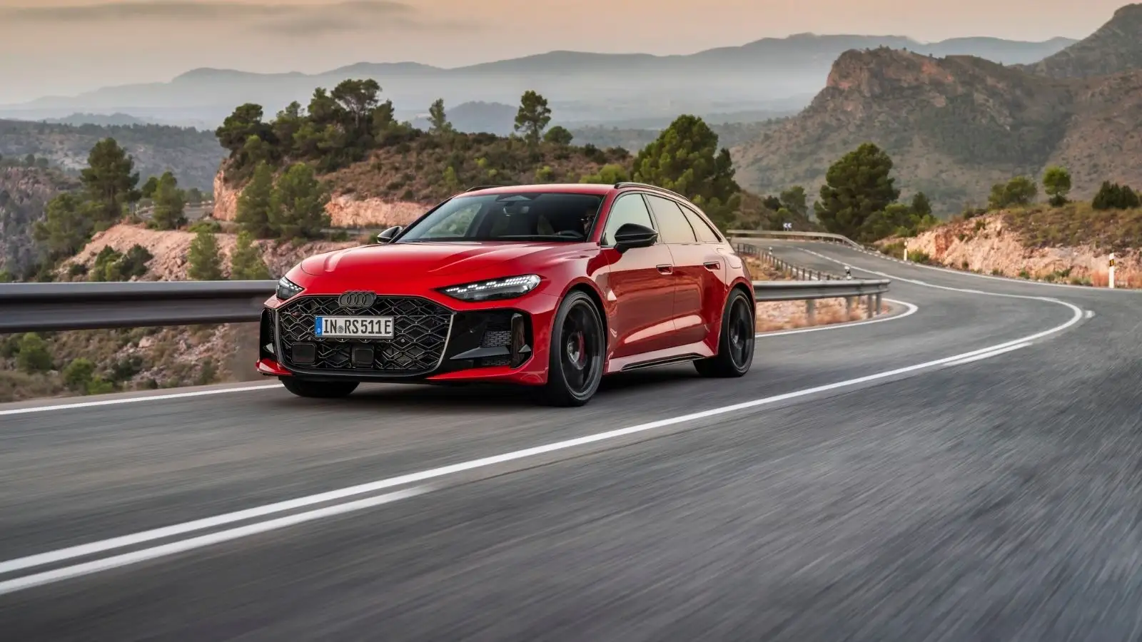 A current-gen red Audi RS 5 Avant on a winding road