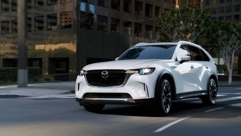A white 2026 Mazda CX-90 PHEV sitting in a parking lot at an angle.