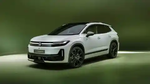 White Volkswagen ID. Tiguan sitting at an angle on a platform with a green surrounding background