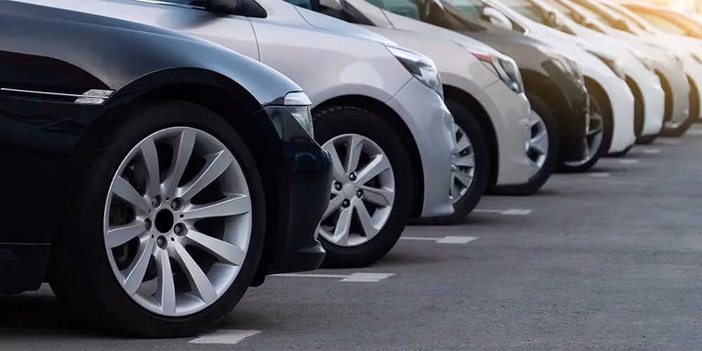 Row of pristine cars in a carpark.