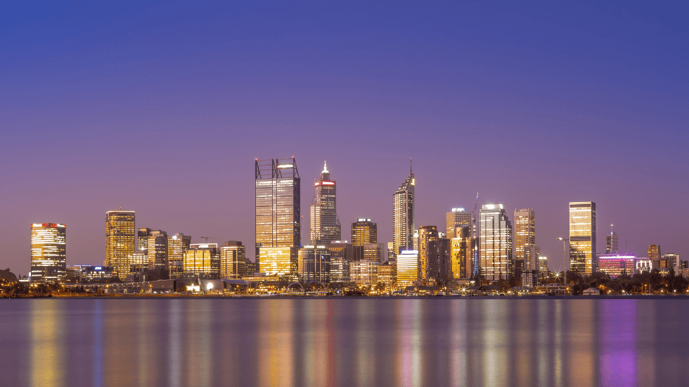 The Perth skyline at a purple-hued sunset.