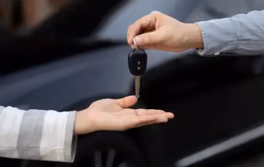 Handing over car keys in Canberra as part of a cash for cars service, showing how to sell your scrap car quickly and hassle-free.