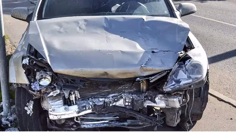 Written-off scrap car in Canberra prepared for free scrap car removal, with parts and metal to be salvaged for cash.