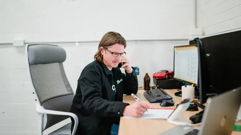 1800 Salvage team member in Canberra arranging paperwork and valuation details to help sellers complete the process of selling a car quickly and easily.