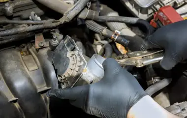 Mechanic dismantling engine components from an old vehicle for scrap car removal in Adelaide.