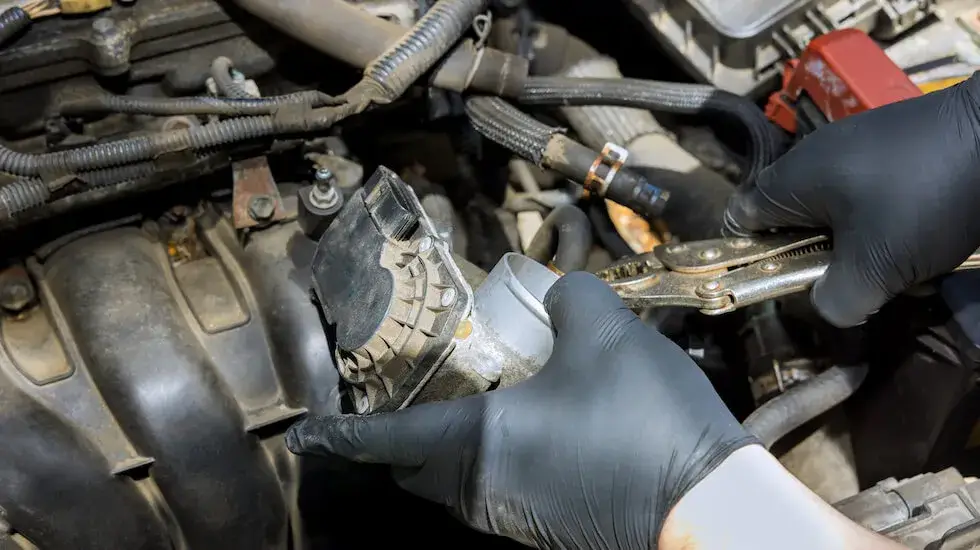 Mechanic dismantling engine components from an old vehicle for scrap car removal in Adelaide.