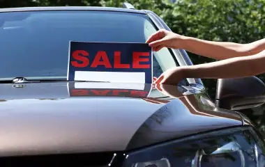 Used car with a sale sign displayed on the windshield in Adelaide, ready for resale.