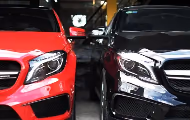 Two cars parked side by side in Darwin, showing front view of motor vehicles ready for sale or trade-in with a dealer or car buying service.