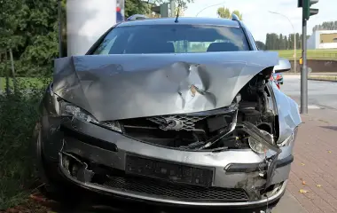 Heavily damaged silver car after accident, example of selling a damaged vehicle in Hobart.