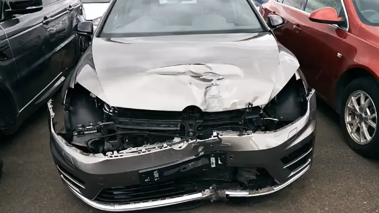 Crashed car awaiting valuation at Hobart salvage yard for old and damaged vehicles.