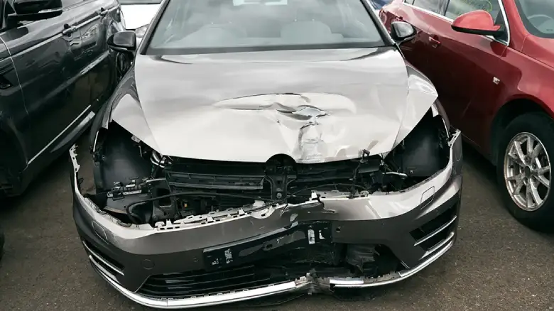 Crashed car awaiting valuation at Hobart salvage yard for old and damaged vehicles.
