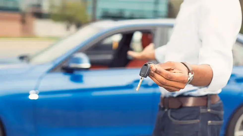Driver holding car keys ready to sell a car in Hobart.